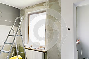 Home renovation concept. Kitchen in process of repair and renovation. Ladder and construction tools