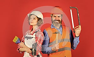 Home renovation. Couple renovating house. Woman builder hard hat. Man engineer or architect. Construction site. Interior