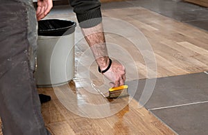 Home renovation parquet. Varnish paintbrush strokes on a wooden parquet