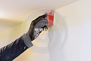 Home renovation on working contractor user in corner paint edger brush painter hands with painting the wall