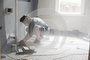 Home renovator using power tools cutting into a wall