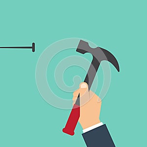 Home repairs concept. Man hammers a nail into a wall. Template construction work. Holding a hammer in hand.