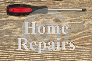 Home Repairs message with screwdriver on weathered wood photo