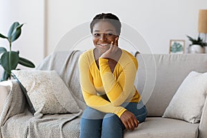 Home Rest. Smiling African Lady Relaxing On Sofa In Living Room