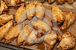 Home roasted chicken wings with honey sauce on a baking tray