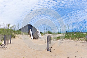 Home roof behind sand dunes 1