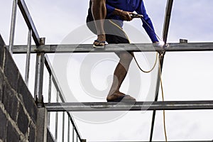 Home roof frame welder. concept working at unsafe height