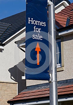 Home for sale sign at new housing development
