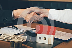 Home sales agents and buyers work on signing new homes and shaking hands