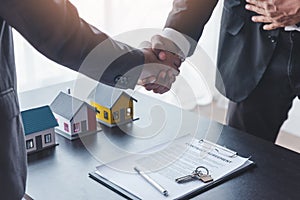 Home sales,home rental and real estate concept.Customer shake hands with real estate agent after sign the document after real