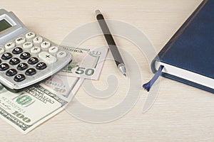 Home savings, budget concept. Calculator, nootepad,pen and money on wooden office desk table