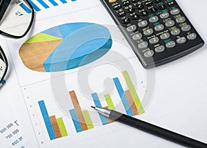 Home savings, budget concept. Chart. pen, calculator and glasses on wooden office desk table