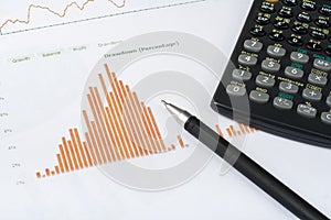 Home savings, budget concept. Chart, pen and calculator on wooden office desk table