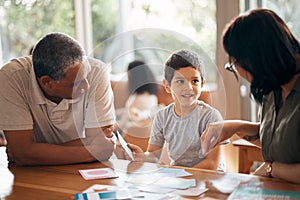 Home school, learning and parents support child with lesson and flash cards for education. Studying, kid and grandfather