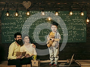 Home school. Support concept. Kid holds teddy bear and performing. Boy presenting his knowledge to mom and dad. Smart