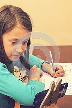 Home schooling. schoolgirl studying homework math during her online lesson at home, social distance during quarantine, self-