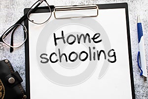 Home schooling word written on wood block. Home schooling text on table, concept