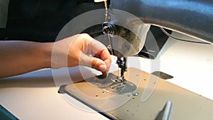 Home seamstress preparing the sewing machine to work. Dressmaker getting ready.