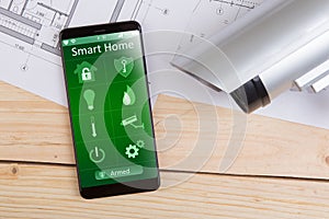 Home security concept smartphone with smart home app and surveillance cctv camera on the desk