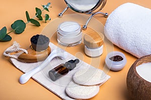 Home self-care kit for face. Dry lymphatic drainage massage brush, mezoroller, loofah pads, natural serum, scrab, cream