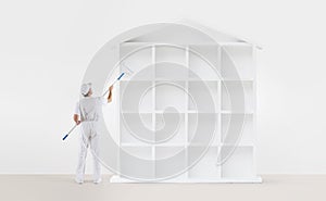 Home service concept. painter man with paint roller, painting a