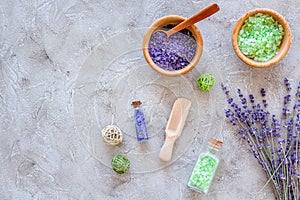 Home spa with lavender herbs cosmetic salt for bath on stone desk background top view mock-up