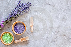 Home spa with lavender herbs cosmetic salt for bath on stone desk background top view mock-up