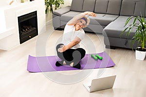 Home Sport. Active Senior Woman Doing Warming Stretching Exercises In Front Of Laptop, Training With Online Tutorials