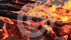 Home style video. Sound. Extreme close-up video of a burning picnic table.