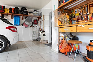 Home suburban car garage interior with wooden shelf, tools equipment stuff storage warehouse on white wall indoor