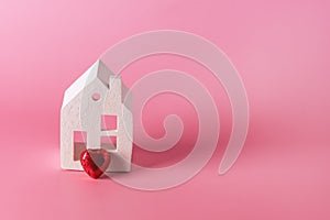 Home Sweet Home Home Symbol with Small Candy Heart Pink Background Copy Space