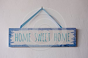 Home sweet home, wooden text on vintage board background