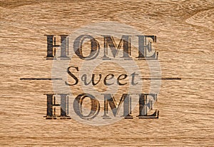 Home sweet home sign on a wood background