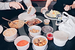 Home table with several containers of delicious Chinese food