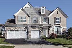 Home with three car stone garage