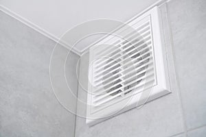 Home vent grille. Forced ventilation in a wall under the ceiling