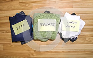 Home wardrobe with different items of clothing. Seasonal clothes sorting. Small space organization photo