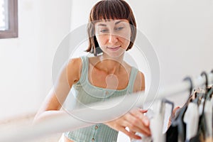 Home wardrobe or dressing room of a clothing store. a young woman chooses a fashionable outfit in her closet at home or in a store