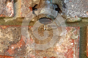 Home water faucet outdoors - spigot - dripping