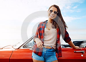 Home is wherever the road takes me. a happy young woman enjoying a summers road trip.