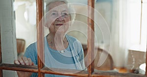 Home, window and senior woman with a smile, thinking and happy with memory, ideas or nostalgia. Pensioner, apartment or