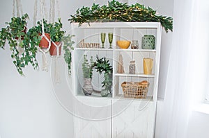 home winter christmas design of interior of kitchen wooden white cupboard with words dream,plants ,yellow and green decorations