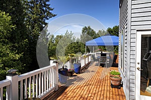 Home wood deck with patio furniture and plants for the summer season