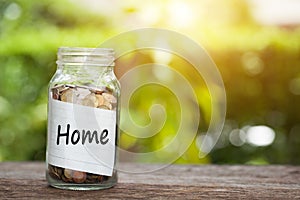 Home Word With Coin In Glass Jar.