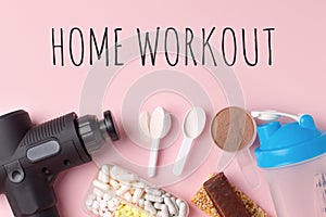 Home workout, lockdown. Therapeutic percussive massage gun, fit meal, pills, sport energy bar on pink background - concept of