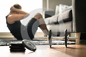 Home workout. Man doing ab training and crunches in living room photo