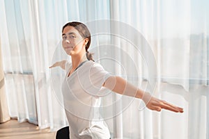 Home workouts. Portrait of a young woman is training at morning. Copy space. Concept of yoga