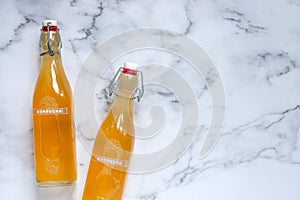Homebrew Kombucha in swing top bottles on marbled background