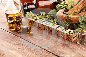 Homegrown and aromatic herbs with rosemary and basil. Wellness sign with wooden cubes