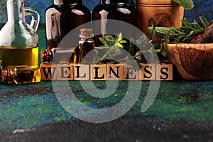 Homegrown and aromatic herbs with rosemary and basil. Wellness sign with wooden cubes